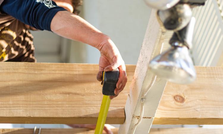 Carpenter measuring plywood